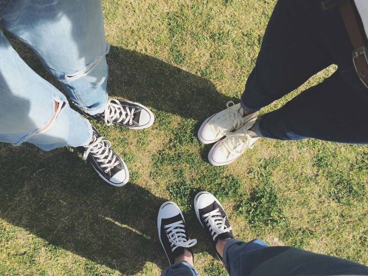 low section, person, shoe, lifestyles, men, leisure activity, standing, personal perspective, footwear, grass, human foot, togetherness, jeans, casual clothing, high angle view, field