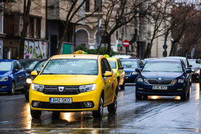 View of wet street in city during rainy season