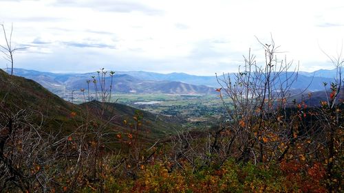 Scenic view of mountains against cloudy sky