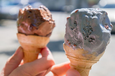 Close-up of hands holding ice cream cones