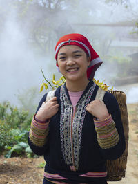 Portrait of smiling young man standing outdoors