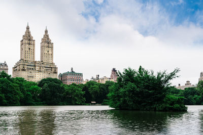 View of building and river against cloudy sky