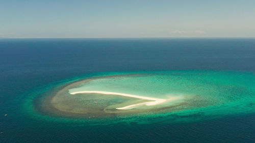 Aerial view of sea against clear sky