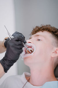 Young guy gets braces with medical equipment