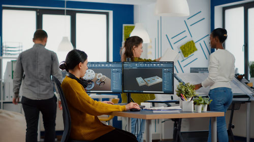 People working on table in office