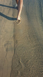 Low section of woman standing on tiled floor