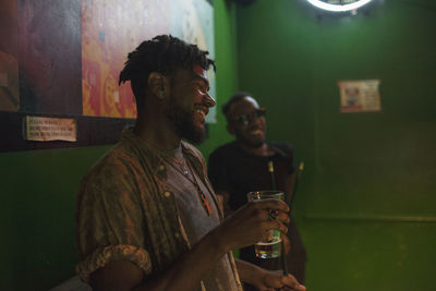 Two young men at a bar.