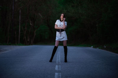 Full length of woman standing on road