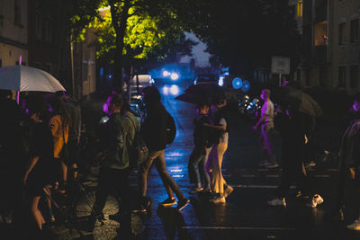 Group of people on wet street during rainy season