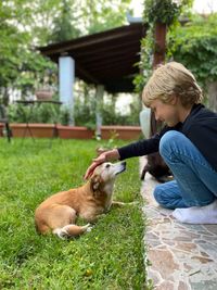 Boy with dog at backyard 