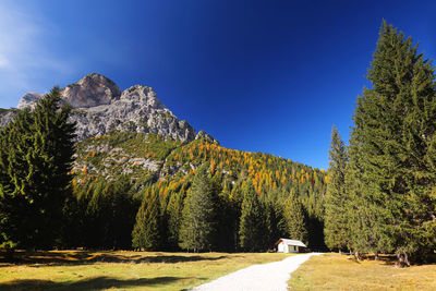 Scenic view of mountain against blue sky