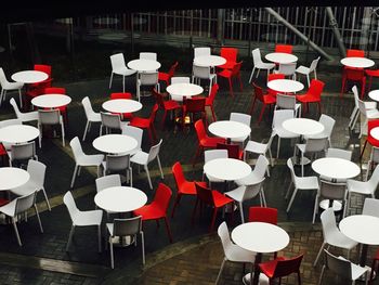 High angle view of empty chairs and tables arranged at cafe