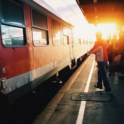 Train and people on platform at sunset