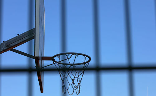 Low angle view of basketball hoop against blue sky