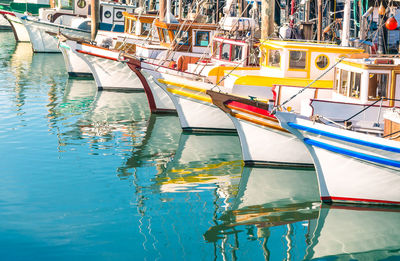 Boats moored at harbor