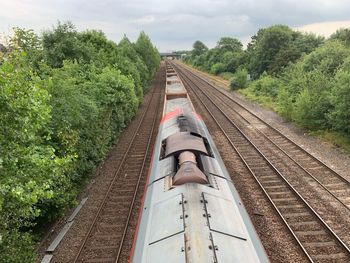 Railroad tracks amidst trees against sky