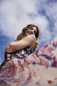 Low angle view of woman against sky