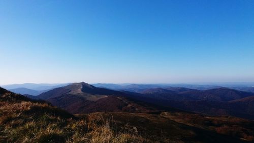 Scenic view of mountains against clear blue sky