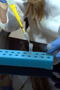 Midsection of woman examining in laboratory