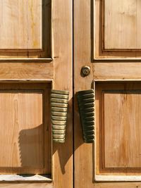 Closeup on a wooden door outdoors, closed entrance with sunlight and copy space 