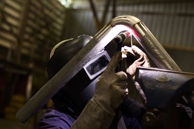 Welder welding in workshop