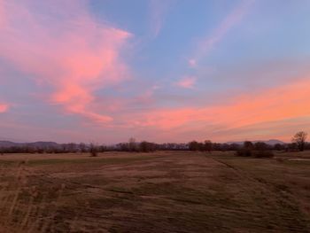 Scenic view of field against sky during sunset