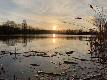 Scenic view of lake against sky during sunset