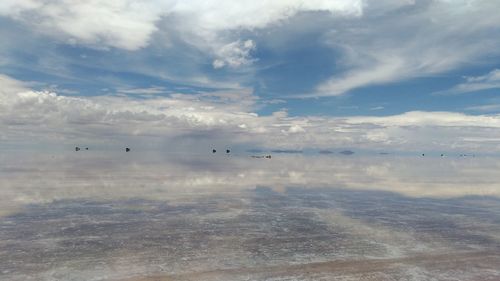 Symmetric view of salt flat and clouds