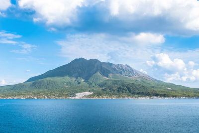 Scenic view of sea and mountains against sky