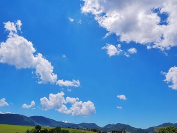 Low angle view of mountain against blue sky