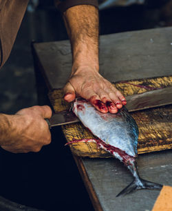 High angle view of man preparing fish