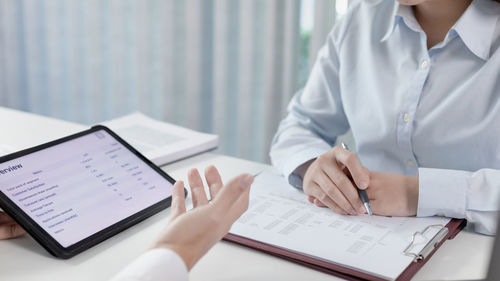 Midsection of doctor working on table