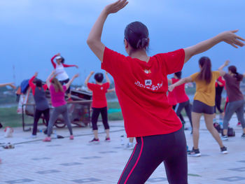 Rear view of women dancing at music concert