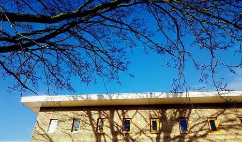 Low angle view of buildings against blue sky