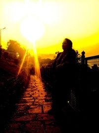 Silhouette man standing against sky during sunset