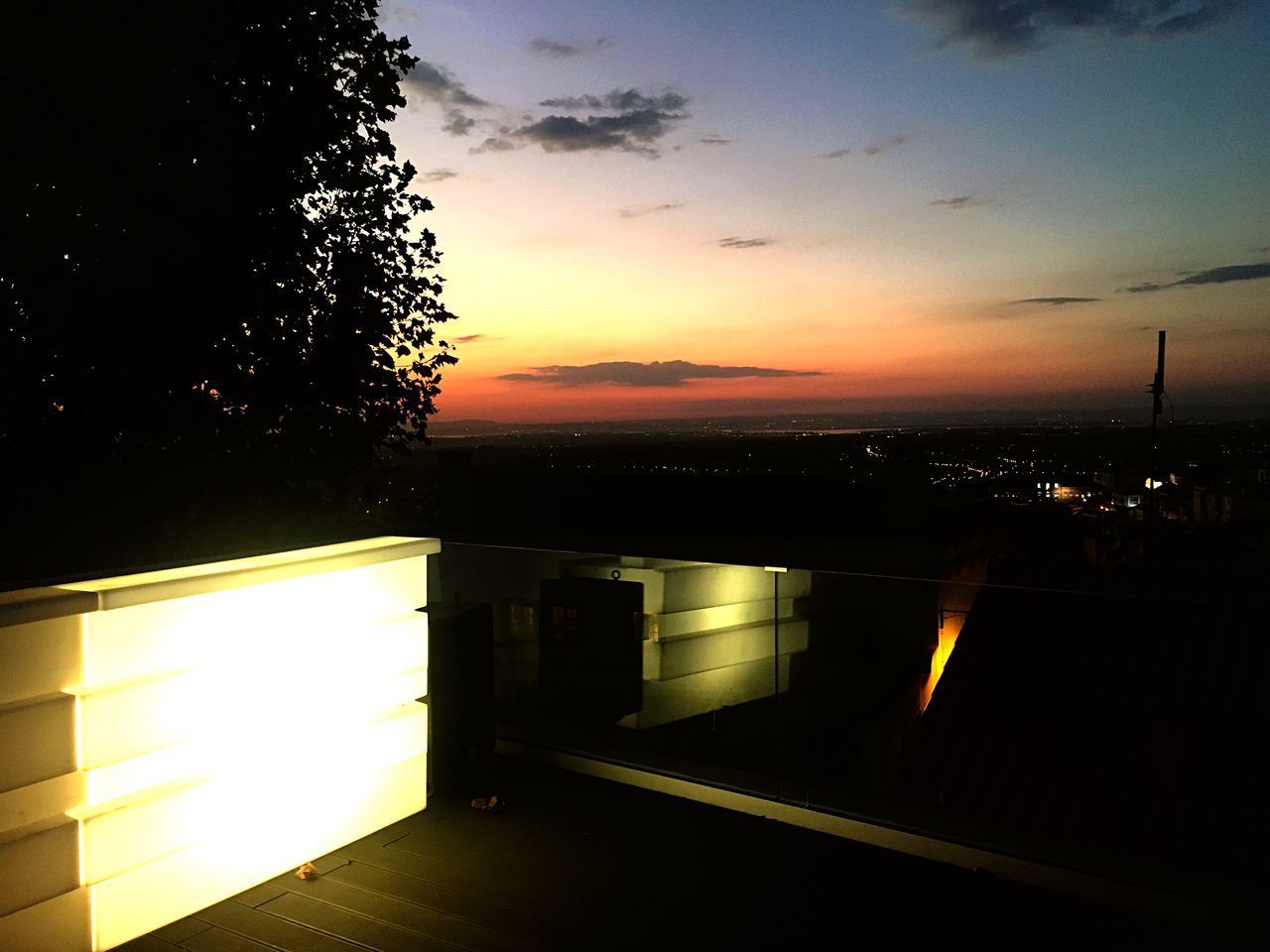 ILLUMINATED BUILDING AGAINST SKY DURING SUNSET