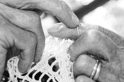 Cropped hands of person knitting wool