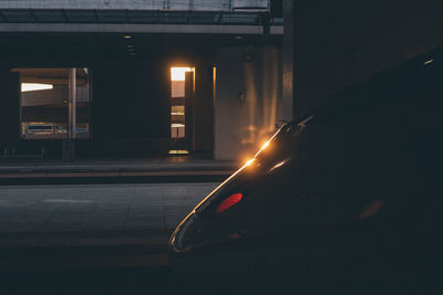 Empty road in illuminated city