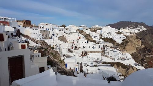 Buildings in town against sky during winter