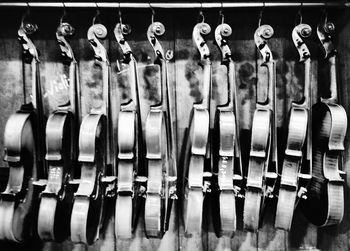 Violins hanging against wall at shop