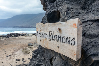 Text on rock at beach