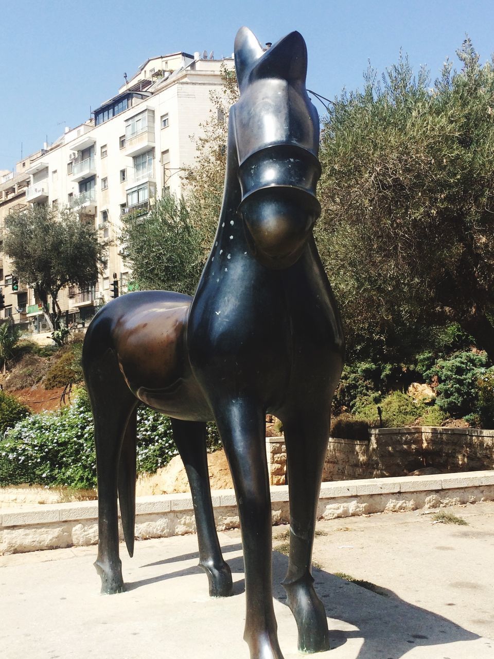 HORSE STATUE AGAINST BUILDINGS