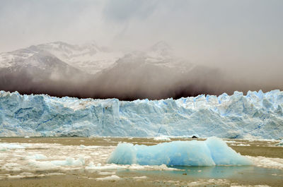 Scenic view of moreno glacier by snowcapped mountain