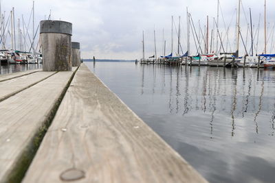 Sailboats moored in sea against sky