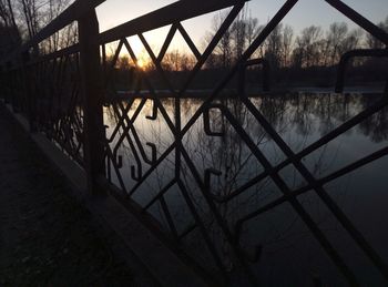 Silhouette bridge against sky during sunset