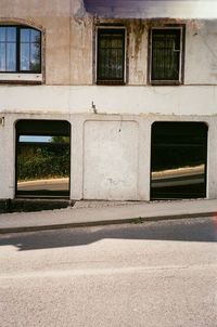 Empty road by building in city