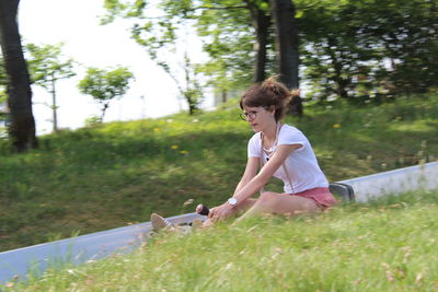 Woman sitting on grassy field