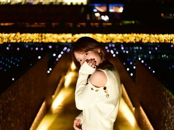 Portrait of girl with illuminated lights at night