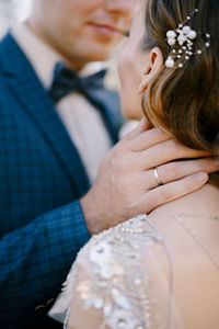 Midsection of bride holding bouquet