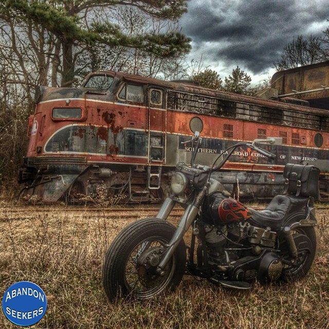 transportation, mode of transport, land vehicle, abandoned, obsolete, sky, run-down, deterioration, damaged, old, rusty, tree, stationary, cloud - sky, day, machinery, railroad track, field, outdoors, tractor